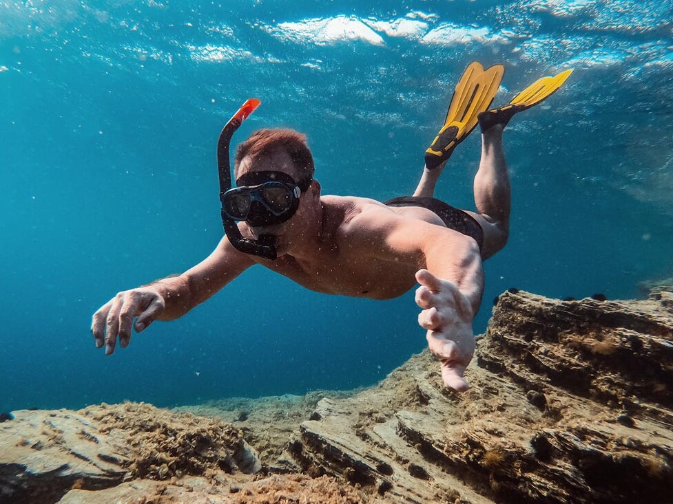 Underwater photo of men snorkeling in Santorini