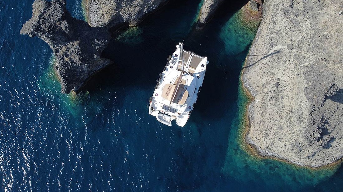 Drone shot of Catamaran in Indian Rocks Santorini