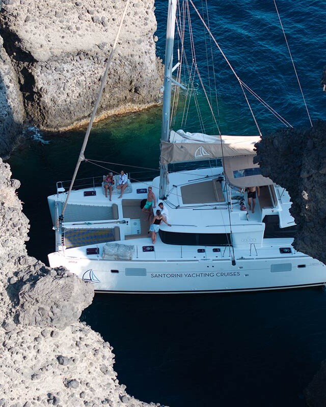 Arial shot of catamaran at the indian rocks in Santorini