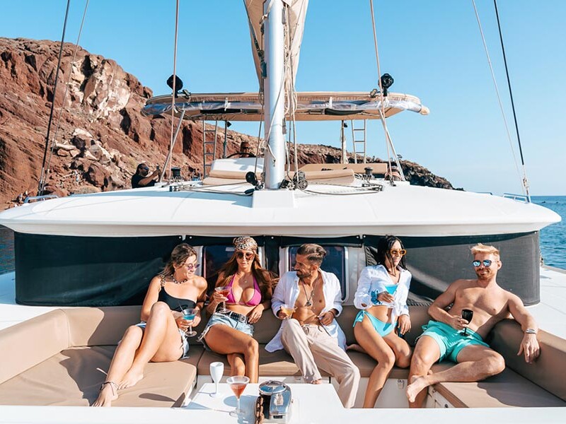 Close up of group of friends on Catamaran in Santorini