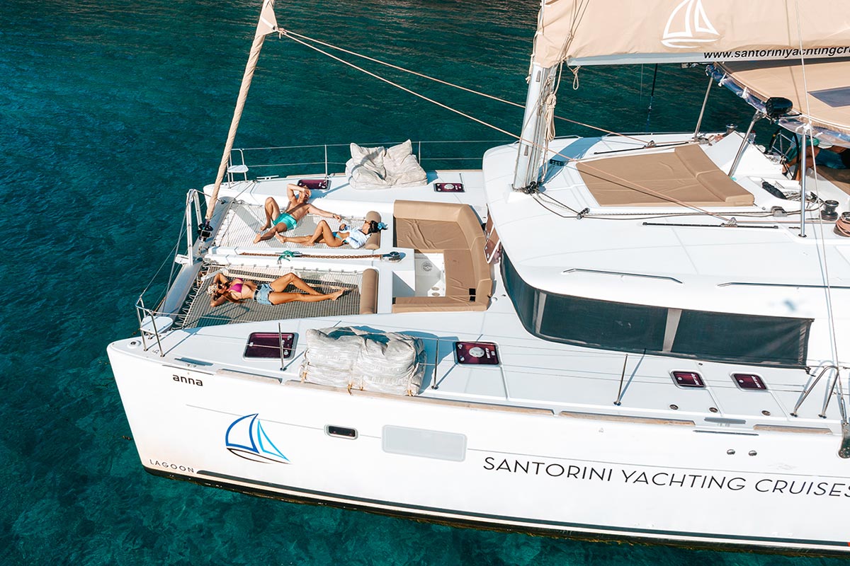 Friends sunbathing on Catamaran in Santorini